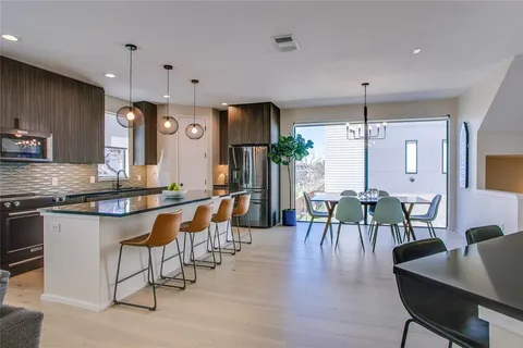 a large kitchen with a table and chairs