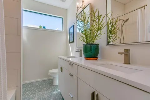 a bathroom with a sink a toilet and mirror