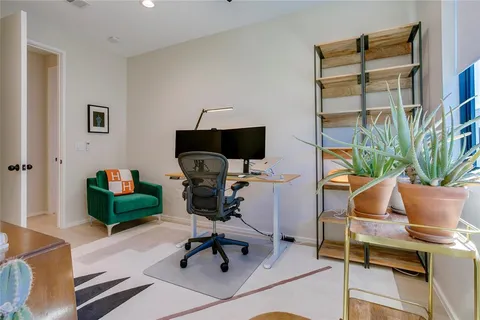 a workspace with furniture and a potted plant