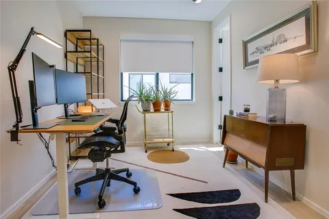 a living room with furniture a rug and a lamp