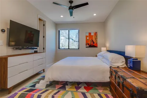 a bedroom with a bed and a flat screen tv