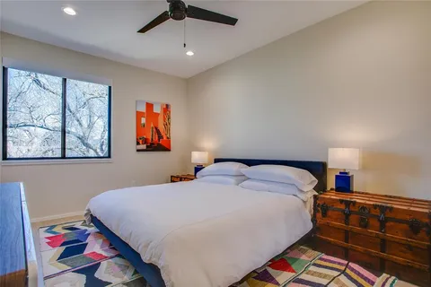 a bedroom with a bed and a painting on the wall