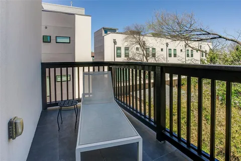 a view of a balcony with furniture