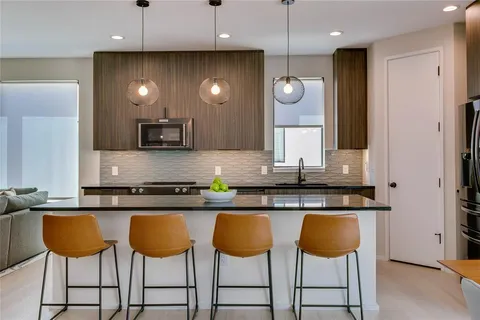 a kitchen with granite countertop a counter top space cabinets and stainless steel appliances
