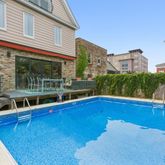 a view of a house with pool and a yard