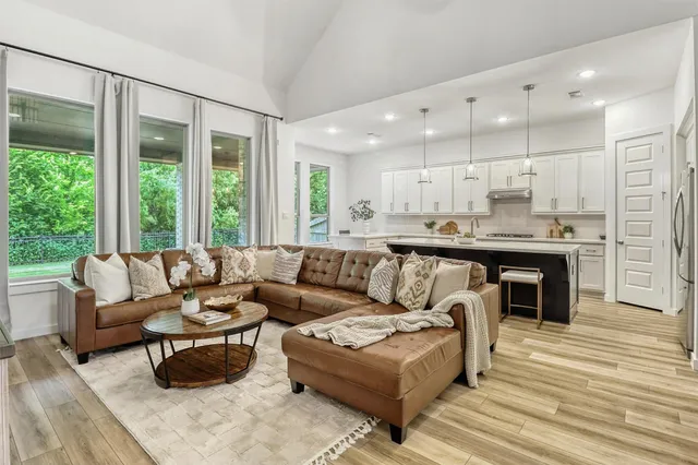 a living room with furniture and a large window