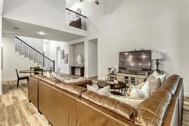 a living room with furniture and large windows