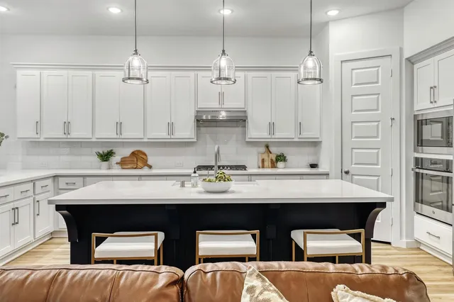 a living room with furniture and kitchen view