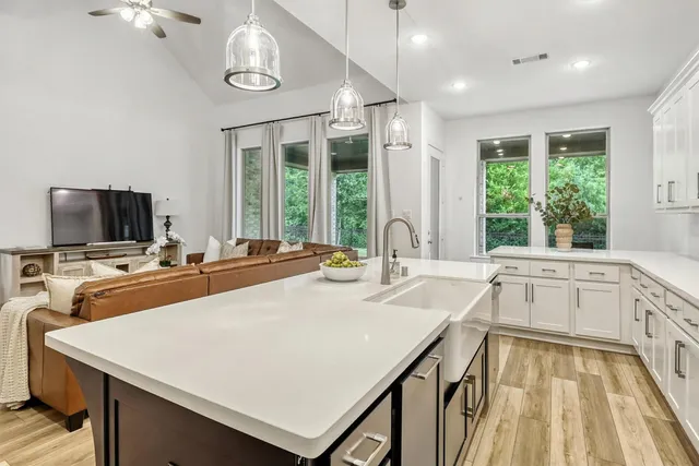 a kitchen with a sink cabinets and window