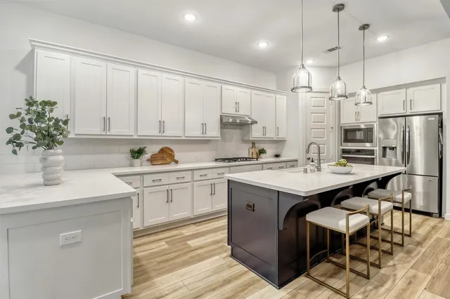 a kitchen with a stove a refrigerator and a stove