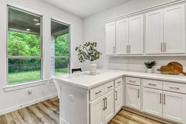 a kitchen with a sink stainless steel appliances and white cabinets