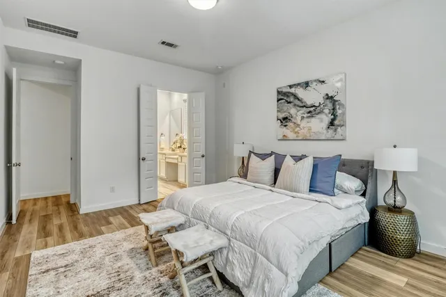 a bedroom with a bed and a large window