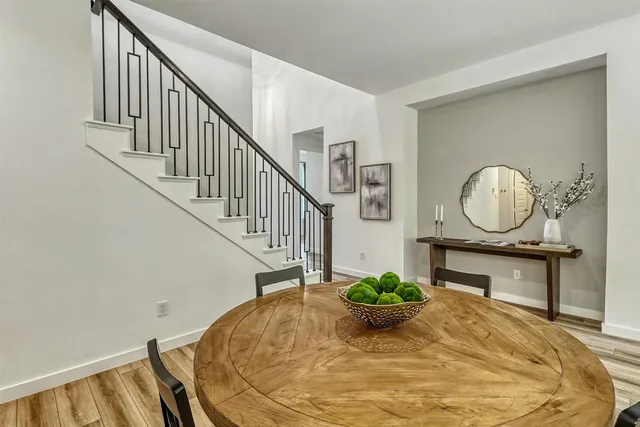 a view of a dining room with furniture and wooden floor