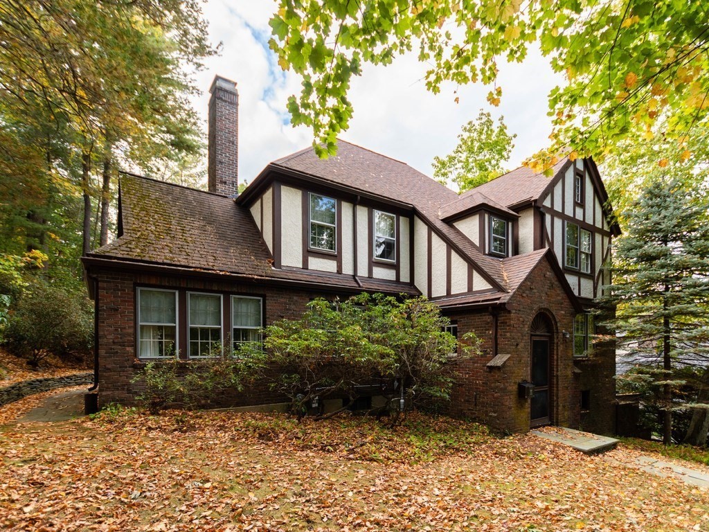9 Sylvan Road Wellesley, MA 02481 - Photo 2 of 8 a front view of a house with a garden