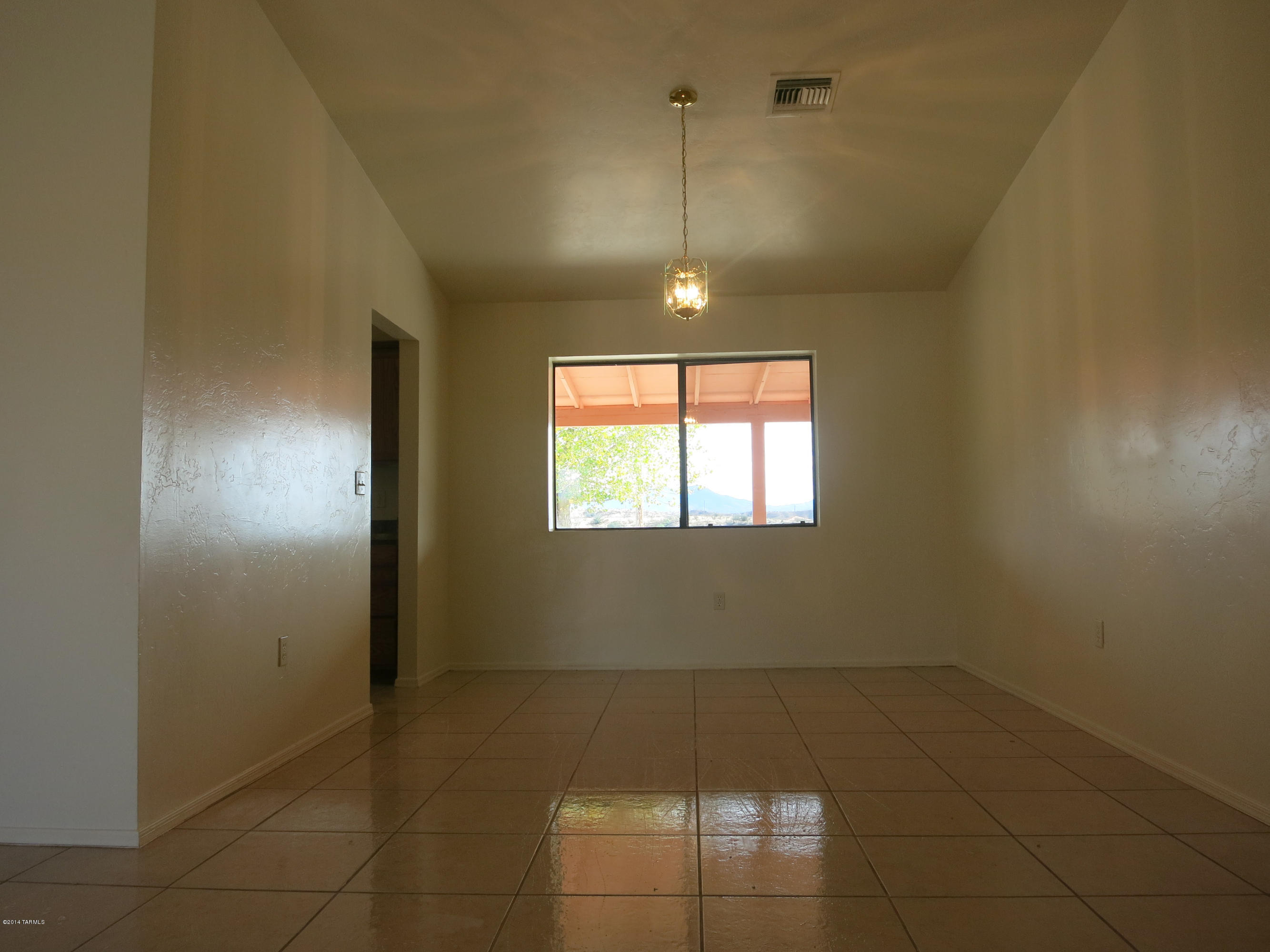 1055 Ameca Court Rio Rico, AZ 85648 - Photo 8 of 18 an empty room with a empty space and windows