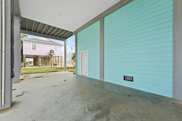 a view of an empty room with entrance and door