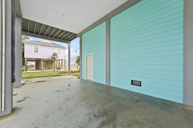 a view of an empty room with entrance and door
