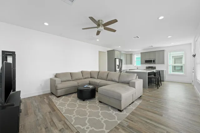 a living room with furniture and kitchen view