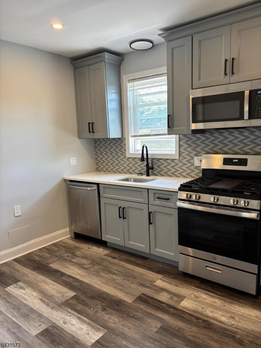 358 Woodland Road, Unit 2 Madison, NJ 07940 - Photo 9 of 50 a kitchen with stainless steel appliances a stove a sink and a microwave