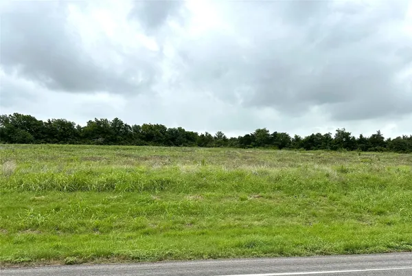 a view of a lake with green field