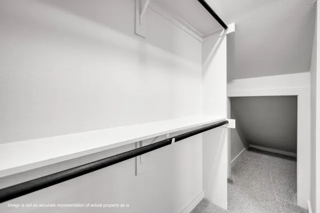 an empty room with a window and doors