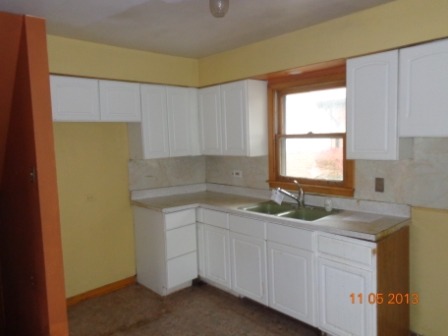 14437 Sanderson Avenue Dolton, IL 60419 - Photo 4 of 8 a kitchen with a sink and cabinets