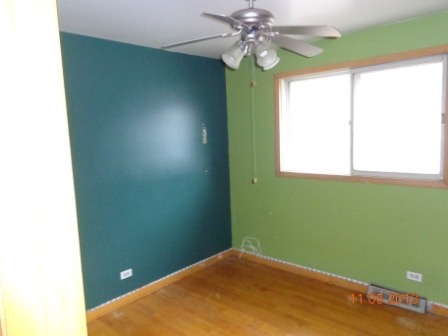 14437 Sanderson Avenue Dolton, IL 60419 - Photo 5 of 8 a view of a room that has a fan and a window