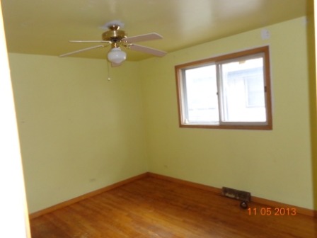 14437 Sanderson Avenue Dolton, IL 60419 - Photo 7 of 8 a view of a room with wooden floor and a window