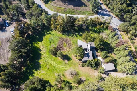 an aerial view of residential house with swimming pool and lawn chairs