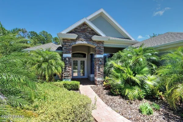 a front view of house with yard and outdoor seating