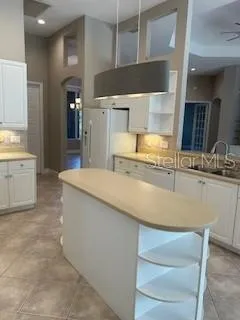 a kitchen with stainless steel appliances granite countertop a sink and a stove