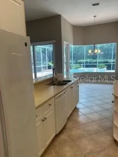 a kitchen with stainless steel appliances granite countertop a sink and a large window