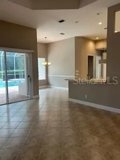 a view of a hallway with a dining table and chair
