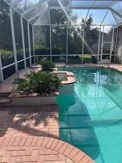 a backyard of a house with fountain table and chairs