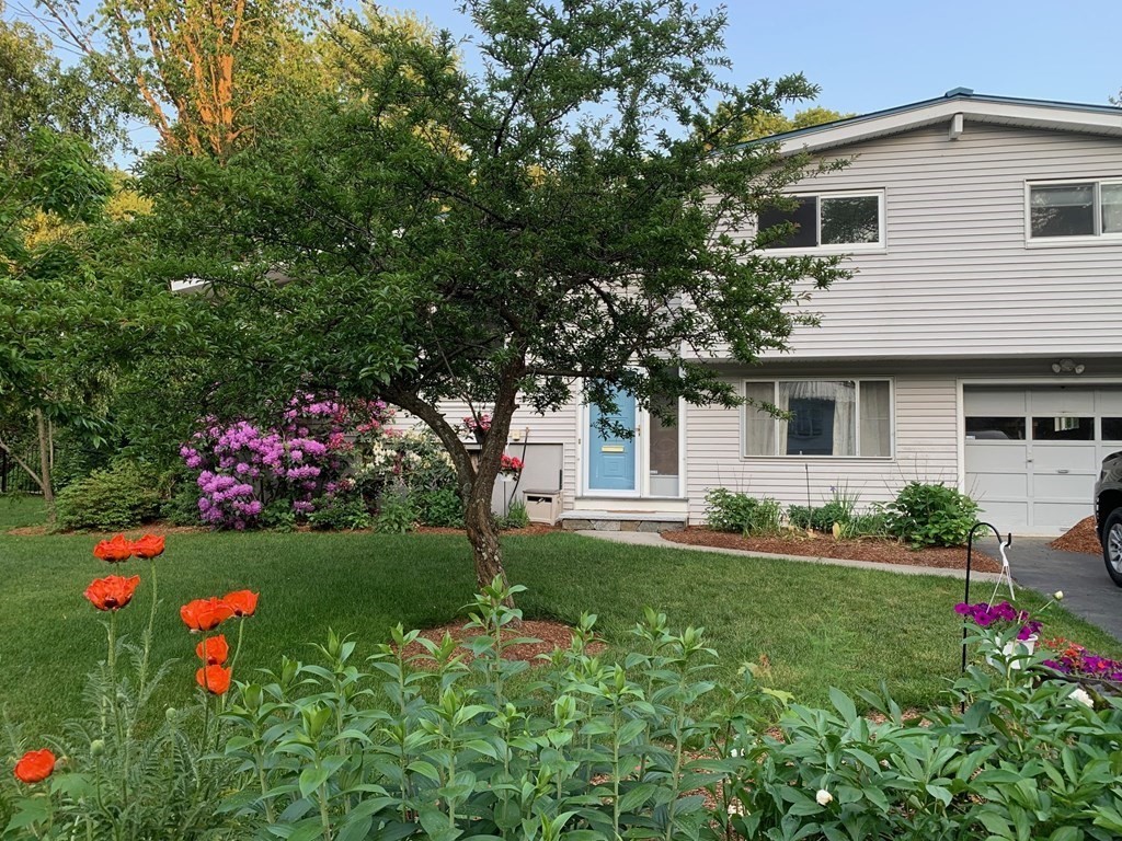 67 Joyce Road Framingham, MA 01701 - Photo 2 of 32 a front view of a house with a yard and garage