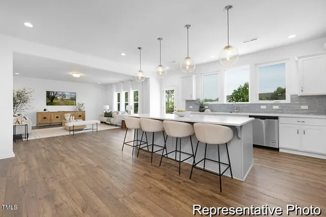 a large kitchen with a table and chairs