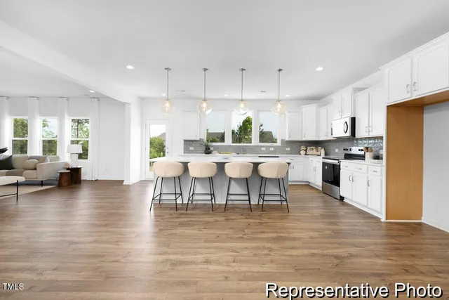a large kitchen with lots of counter space and furniture