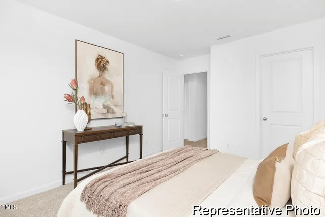 a bedroom with a bed and a painting on the wall