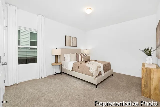 a bedroom with a bed and a potted plant