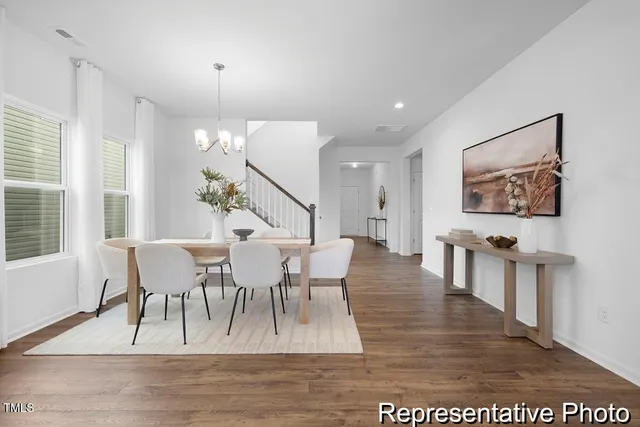 a view of a dining room with furniture window and wooden floor