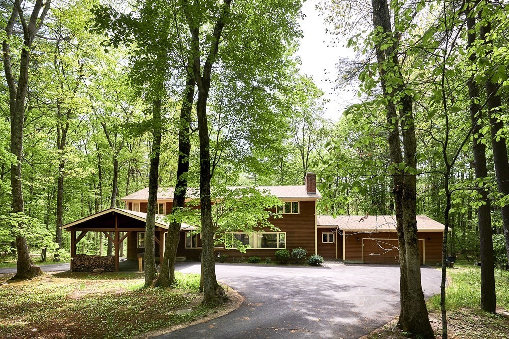 a view of a house with backyard and a tree