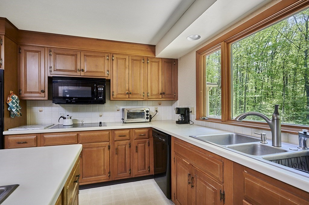 64 Cushman Road Shutesbury, MA 01002 - Photo 11 of 41 a kitchen with a sink a microwave and cabinets