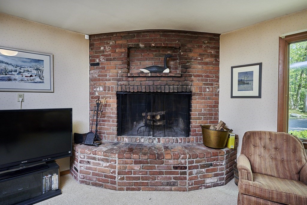 64 Cushman Road Shutesbury, MA 01002 - Photo 13 of 41 a living room with furniture a flat screen tv and a fireplace