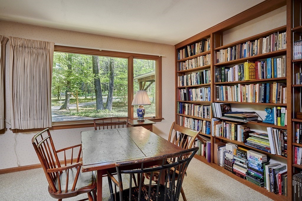 64 Cushman Road Shutesbury, MA 01002 - Photo 14 of 41 a view of a workspace with furniture and a bookshelf