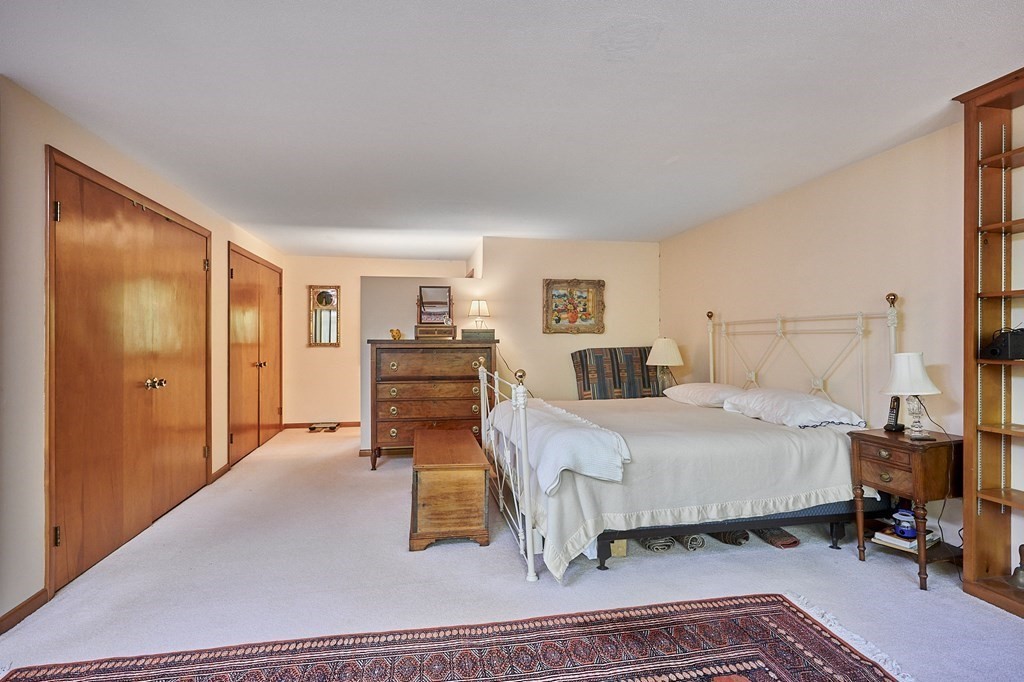 64 Cushman Road Shutesbury, MA 01002 - Photo 17 of 41 a bedroom with a bed and wooden floor