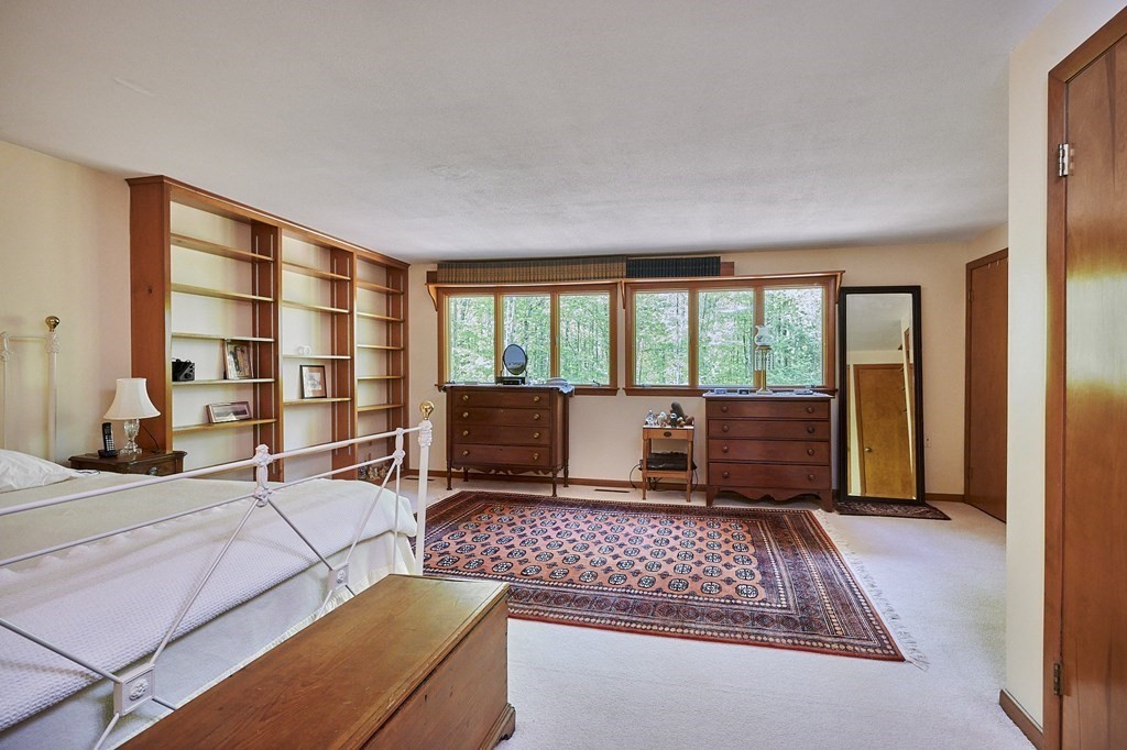 64 Cushman Road Shutesbury, MA 01002 - Photo 18 of 41 a living room with furniture and a floor to ceiling window