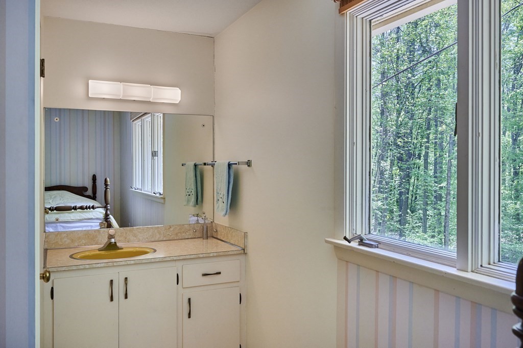 64 Cushman Road Shutesbury, MA 01002 - Photo 23 of 41 a bathroom with a granite countertop sink and a mirror