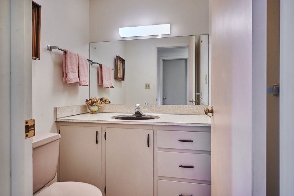 64 Cushman Road Shutesbury, MA 01002 - Photo 24 of 41 a bathroom with a granite countertop sink mirror and toilet