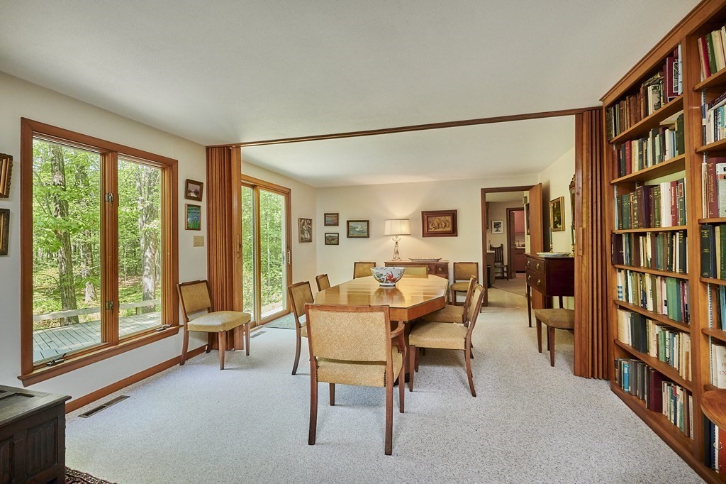 64 Cushman Road Shutesbury, MA 01002 - Photo 9 of 41 a dining room with furniture and a book shelf