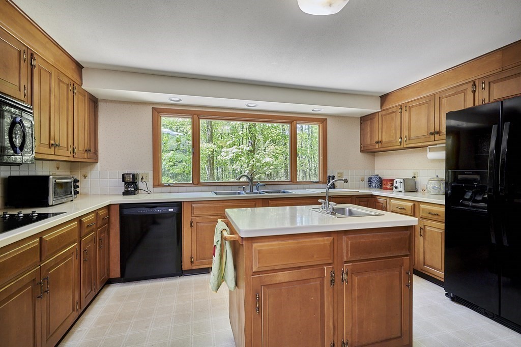 64 Cushman Road Shutesbury, MA 01002 - Photo 10 of 41 a kitchen with stainless steel appliances granite countertop a sink stove and refrigerator